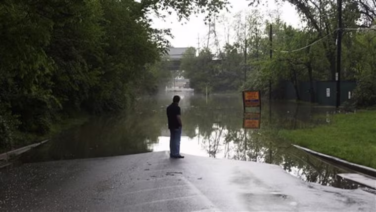 A man observes flooding on Frankfort Avenue near River Rd. in Louisville, Ky., on Monday, April 25, 2011. (AP Photo/The Courier-Journal, Tyler Bissmeyer)